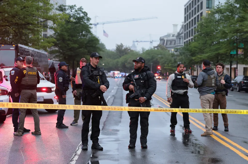 Law enforcement agents stand behind police tape after the shooting on May 23, 2026.