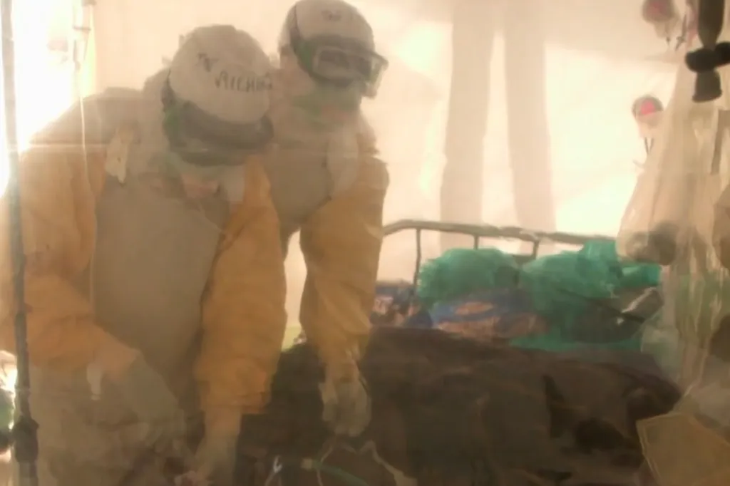 Medical personnel in hazmat suits caring for a patient.