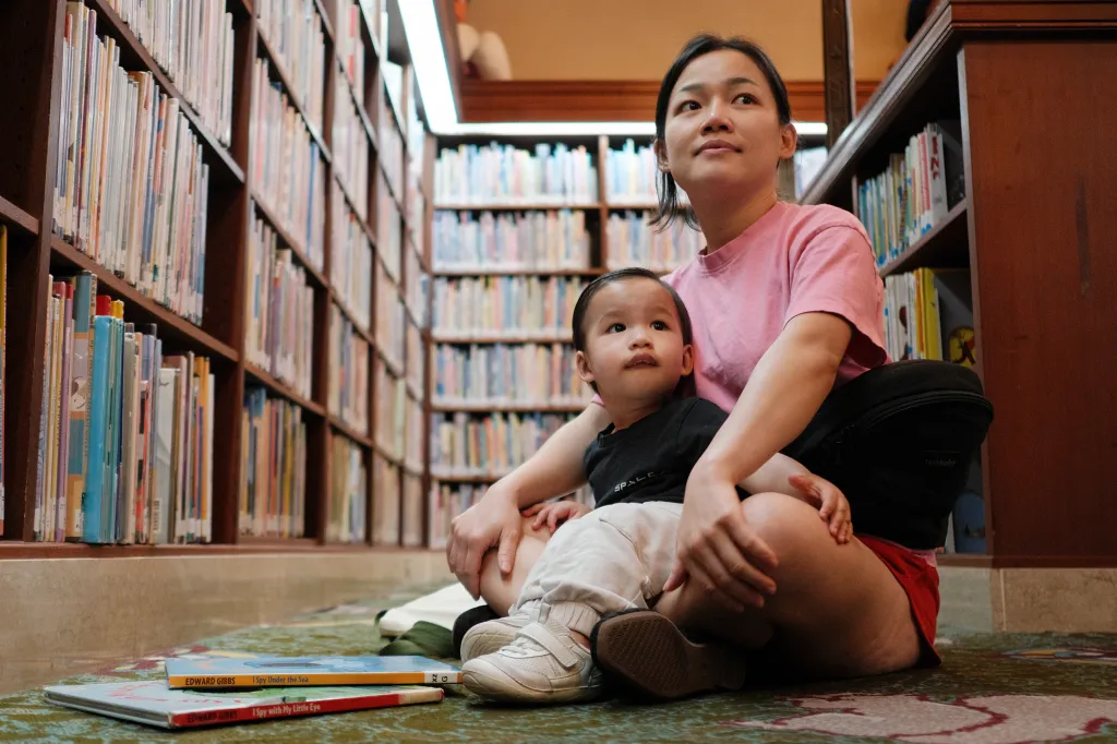 Mae Munoz and her son read in the children's section of the Los Angeles Central Library.