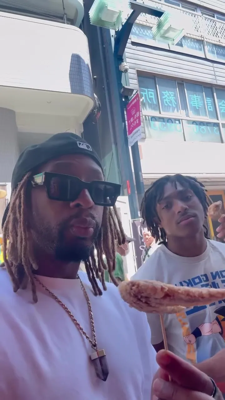 Lil Jon and his son trying various foods on a stick in an Instagram video.