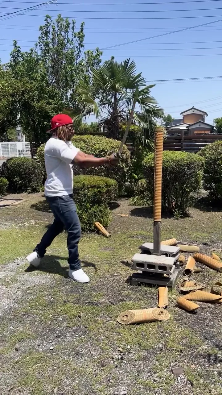 Lil Jon slicing a bamboo mat with a samurai sword.