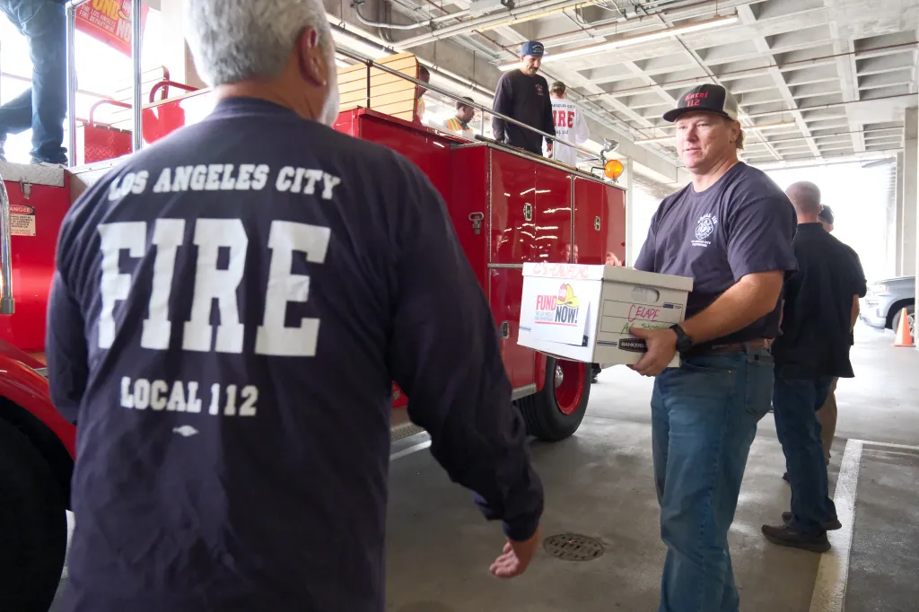 Firefighters from Los Angeles Fire Department Local 112 collect signatures for a proposed ballot measure.