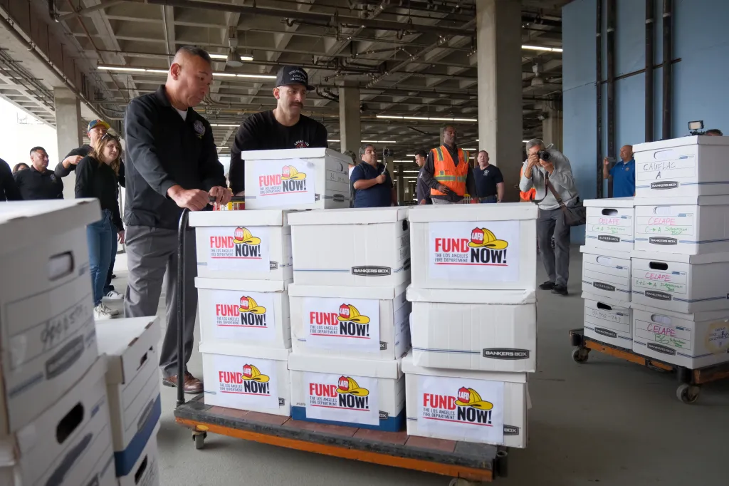 Los Angeles firefighters with boxes of signatures for a proposed ballot measure to fund the LAFD.
