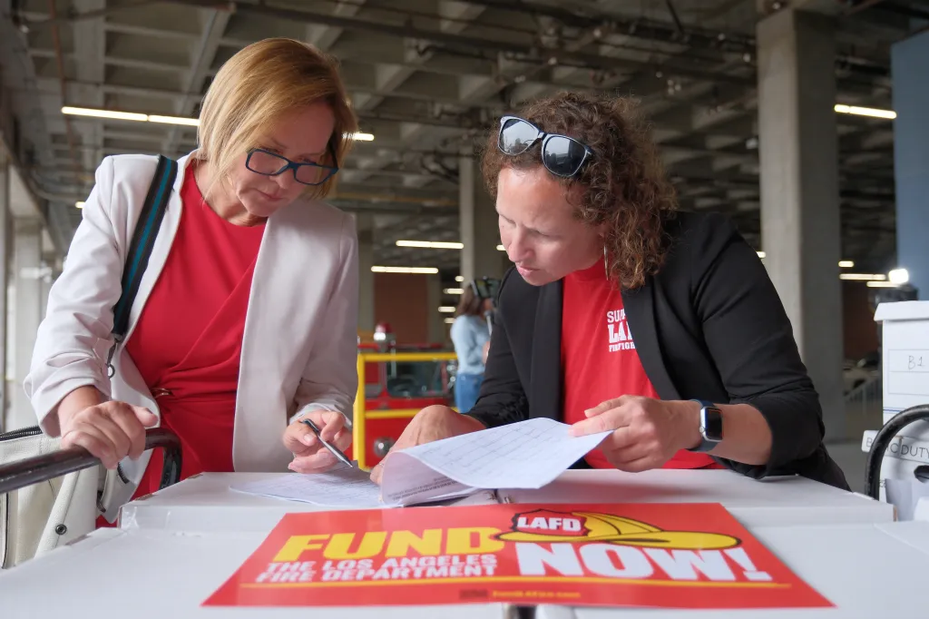 Councilwoman Traci Park signing documents to support Los Angeles firefighters.
