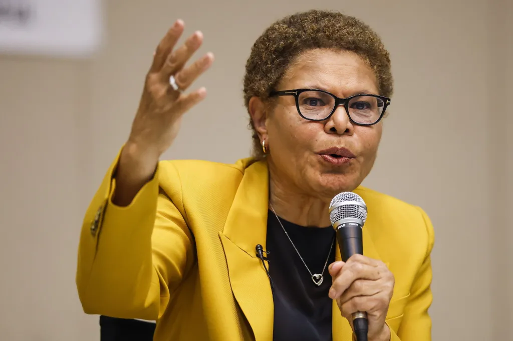 Los Angeles Mayor Karen Bass speaking into a microphone during a mayoral debate.