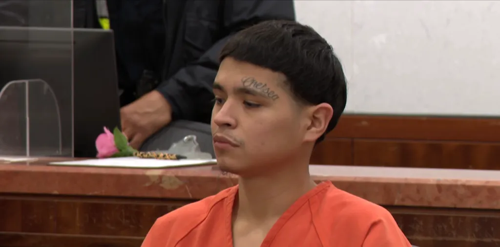 Raudel Orozo in an orange jumpsuit, with a 