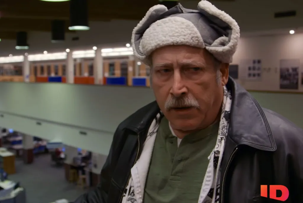 Man in a trapper hat and leather jacket with a mustache.