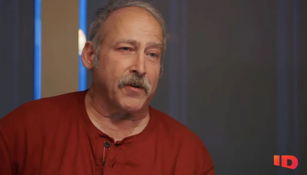 Benjaman Kyle, a man who suffered from amnesia, looks forward while wearing a red shirt.