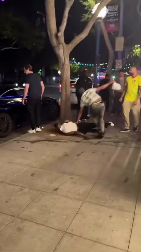 A man is knocked out on the ground during a brawl in West Hollywood.