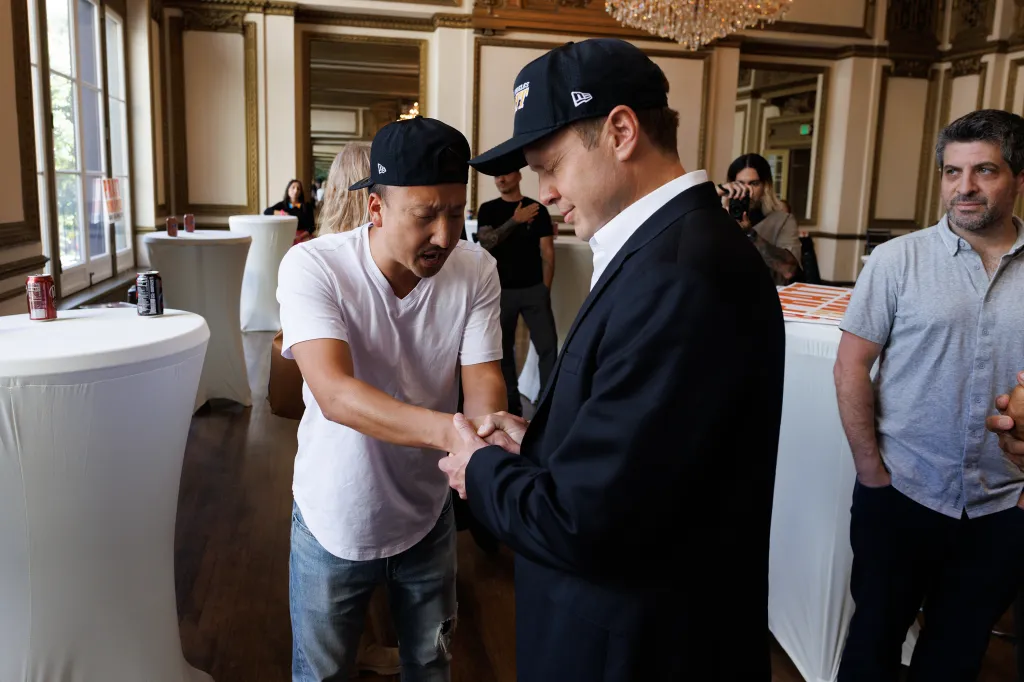 A man praying with Spencer Pratt at a mayoral campaign meet and greet.