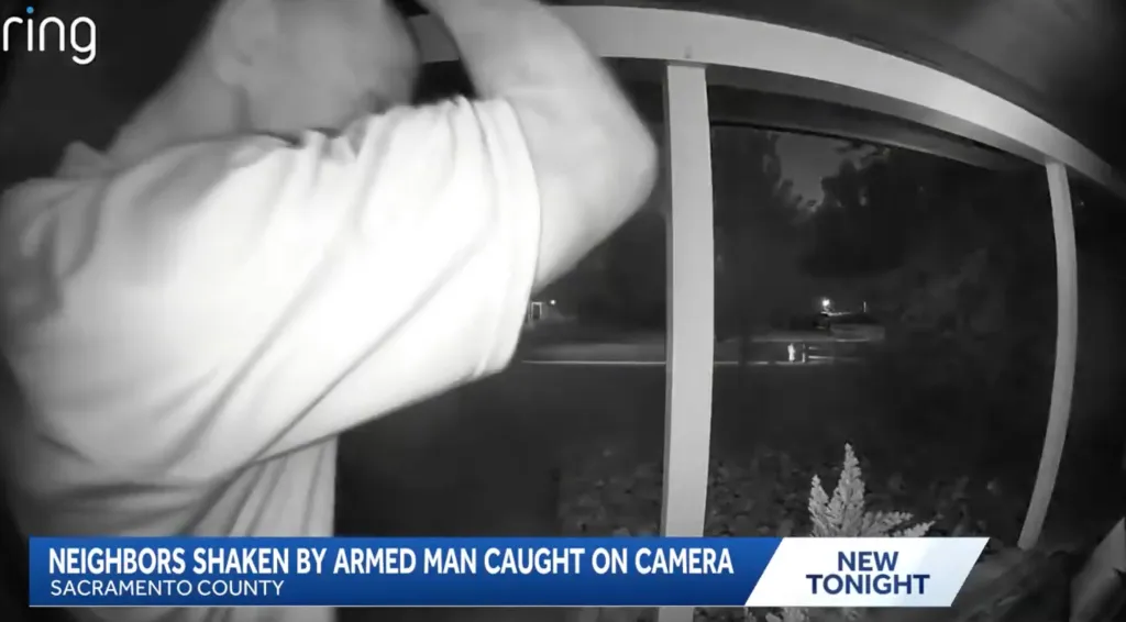 A man holding a knife and making stabbing motions at a door, captured by a Ring camera.