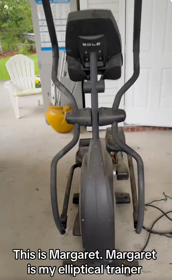 A black elliptical trainer on a patio.
