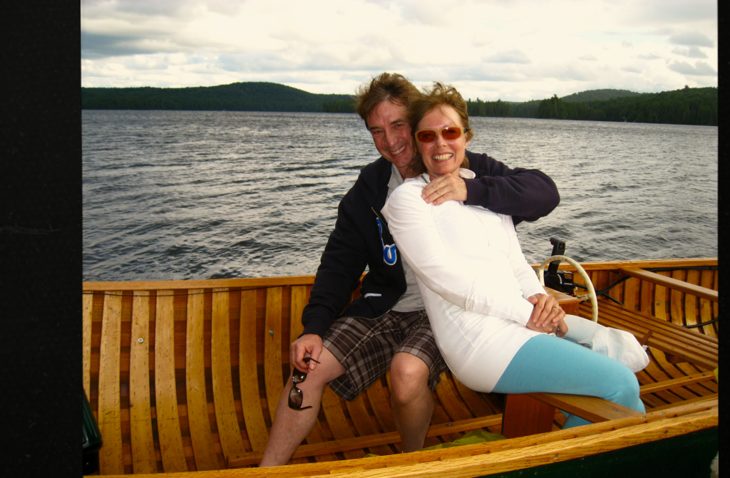 Martin Short and Nancy Dolman in a boat on a lake.