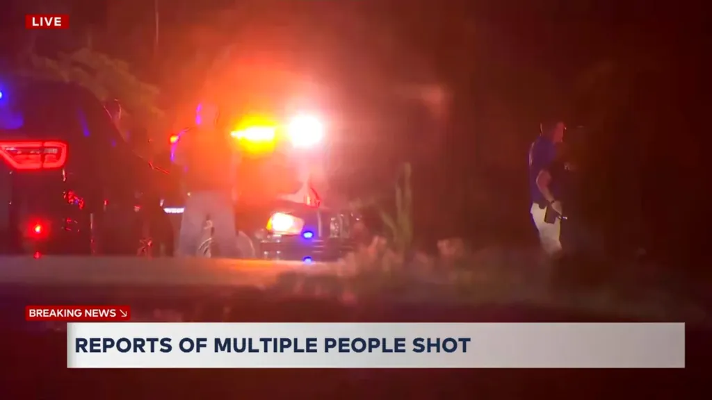 Police cars with flashing lights and officers on scene at a mass shooting at a campground in Edmond, Oklahoma.