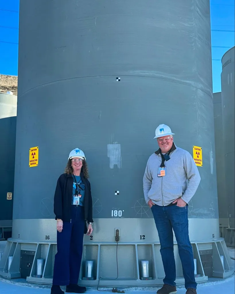 Maureen Zawalick, Senior Vice President and Chief Risk Officer of PG&E, with another person, standing in front of a radioactive material storage container.