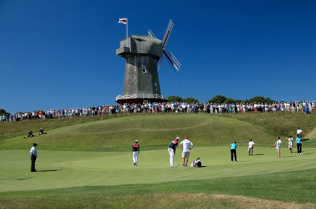 Golfers Max Homa and Michael Kim watching Garick Porteous putting during the 2013 Walker Cup Match.