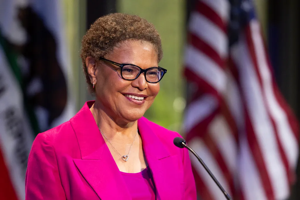Mayor Karen Bass smiling at the podium during the NBC4 and Telemundo 52 debates.