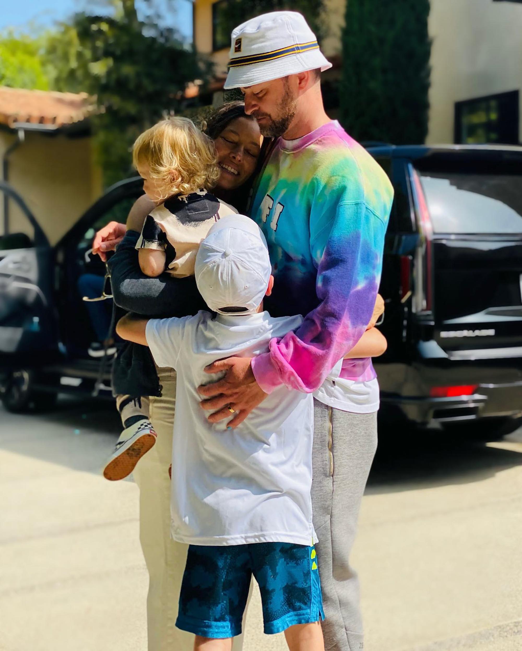 Justin Timberlake, Jessica Biel, and their two children embracing.