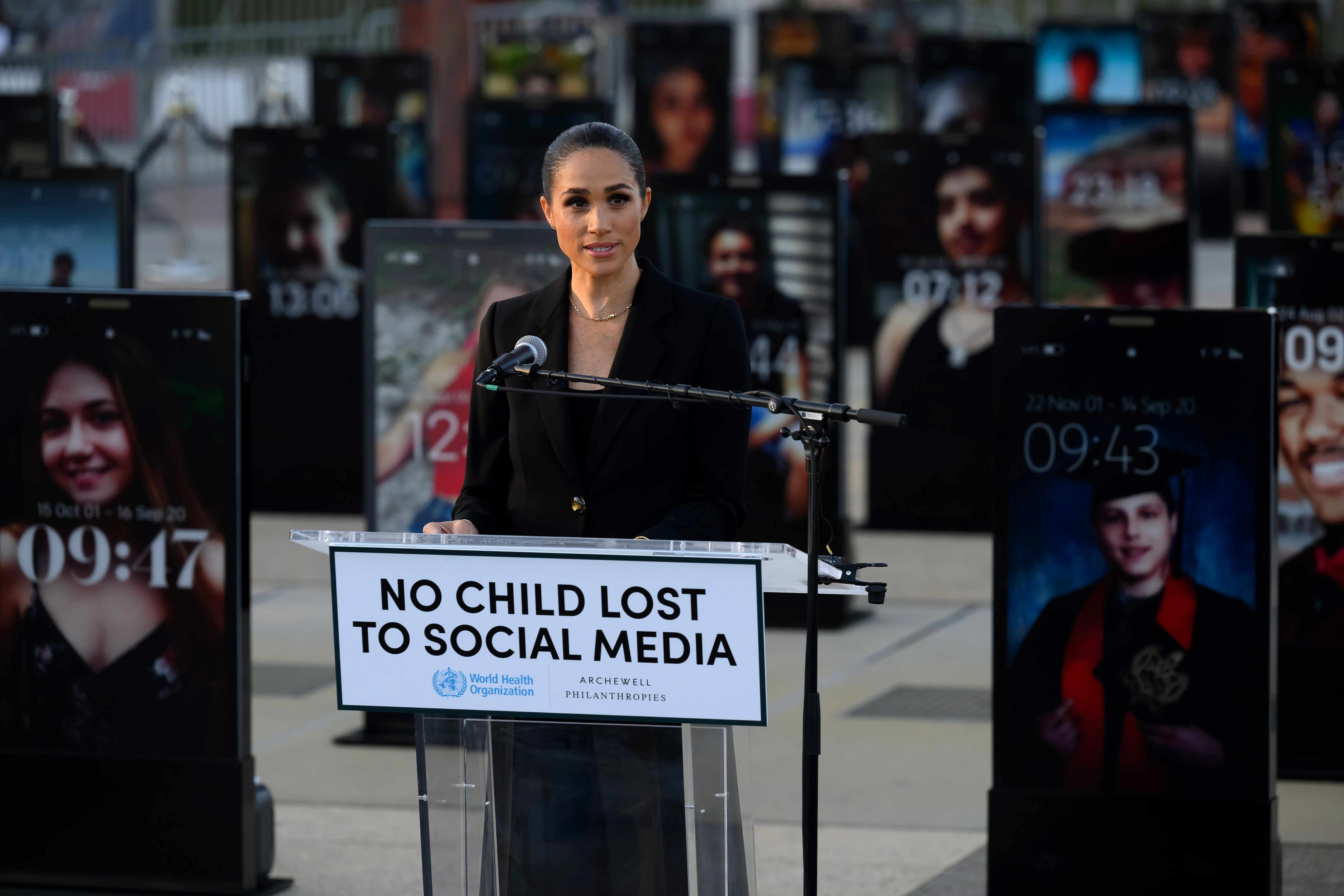 Meghan Markle speaking at a podium that says 