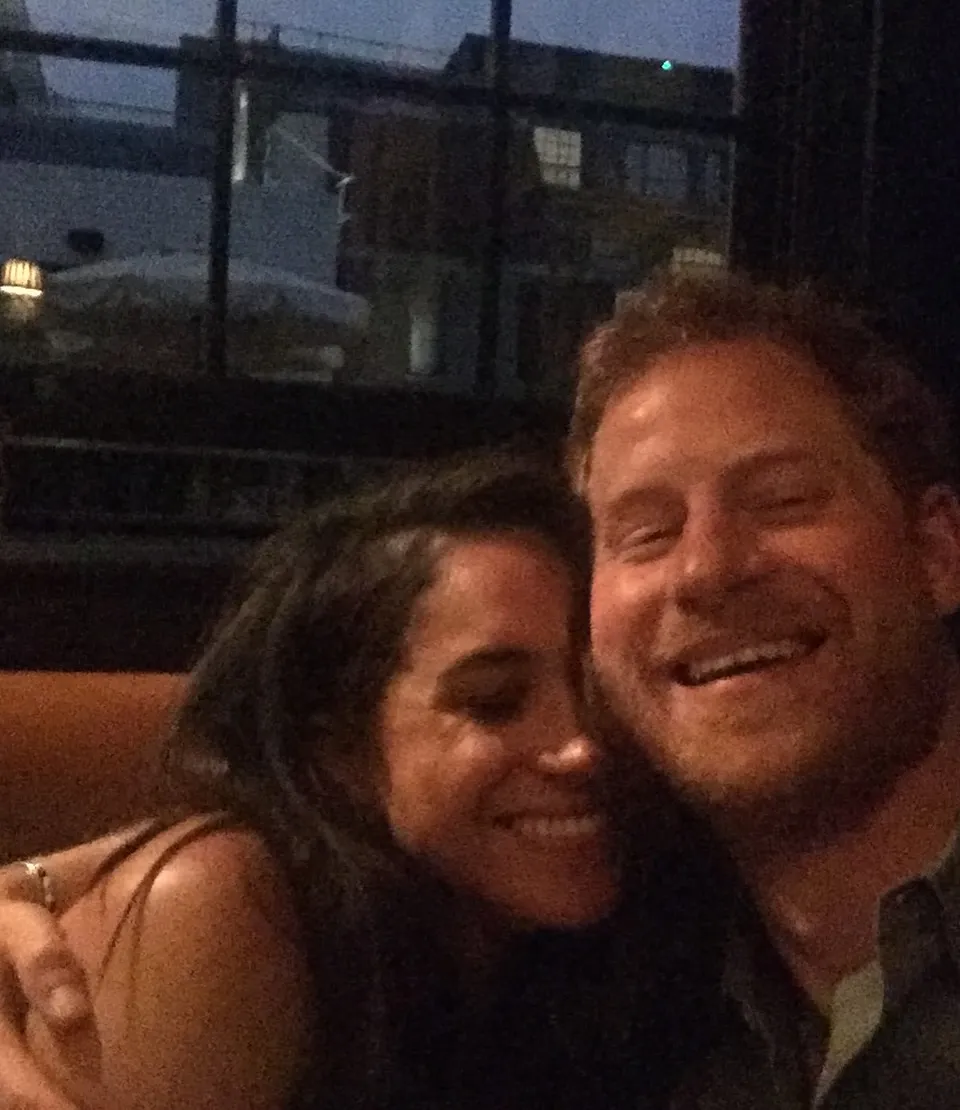 Meghan Markle and Prince Harry smiling and laughing together.