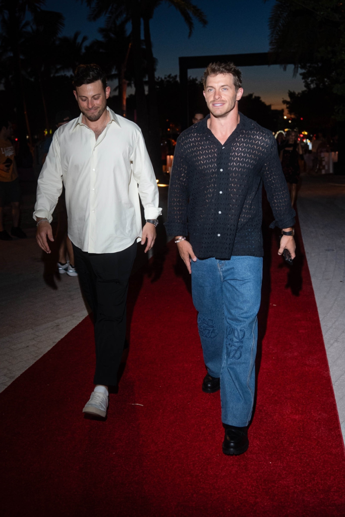 Braxton Berrios in a black mesh shirt and jeans walks the red carpet at the Carbon Beach 2026 event.