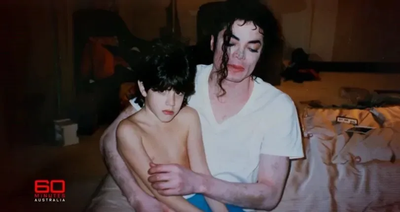 Michael Jackson sitting with nine-year-old Dominic Cascio, who looks uncomfortable, in a hotel room in 1996.