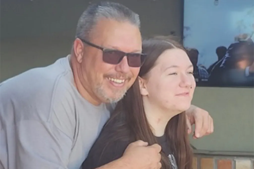 Michael Sanchez smiling, with his arm around a young woman.