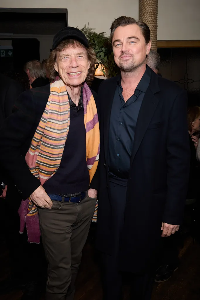 Mick Jagger and Leonardo DiCaprio smiling at the 