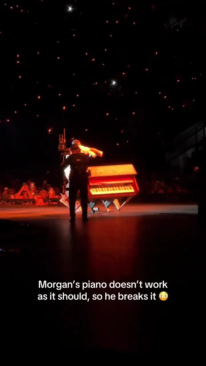 Morgan Wallen pushing a piano over on stage during a concert.