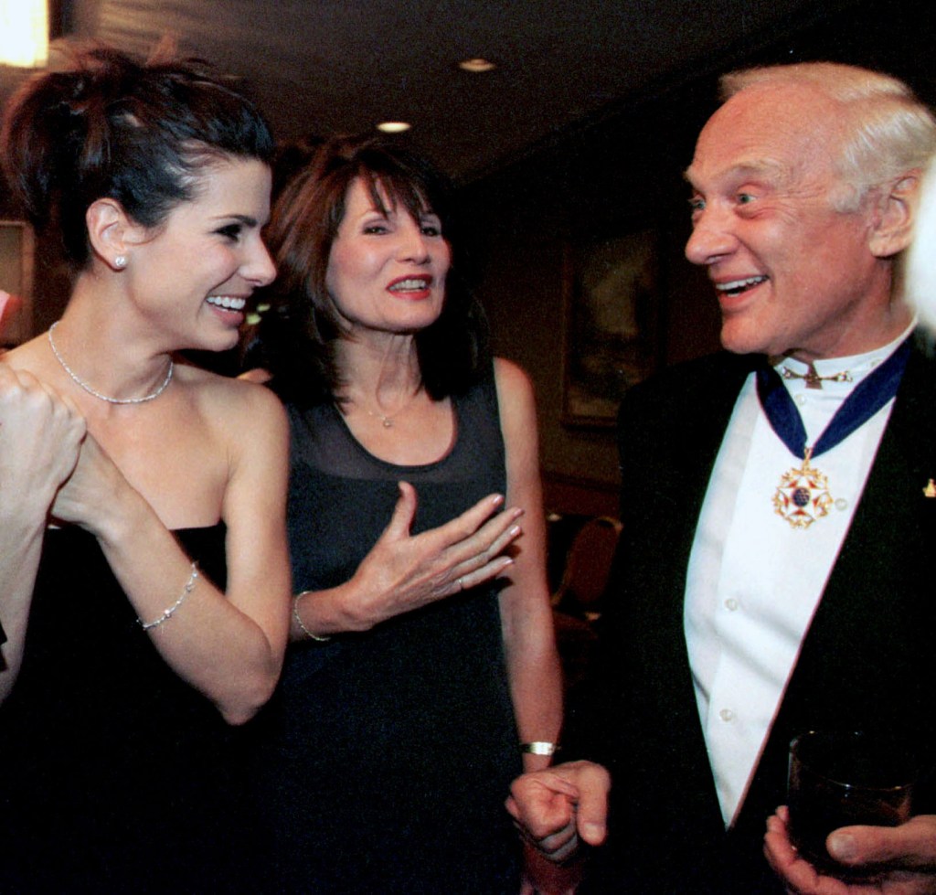 Sandra Bullock and her mother Helga laughing with Buzz Aldrin at the Lombardi Gala.