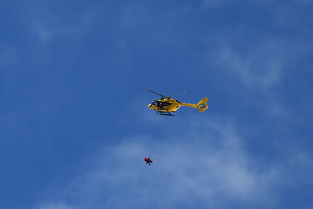 A mountain rescue helicopter rescuing Lindsey Vonn.
