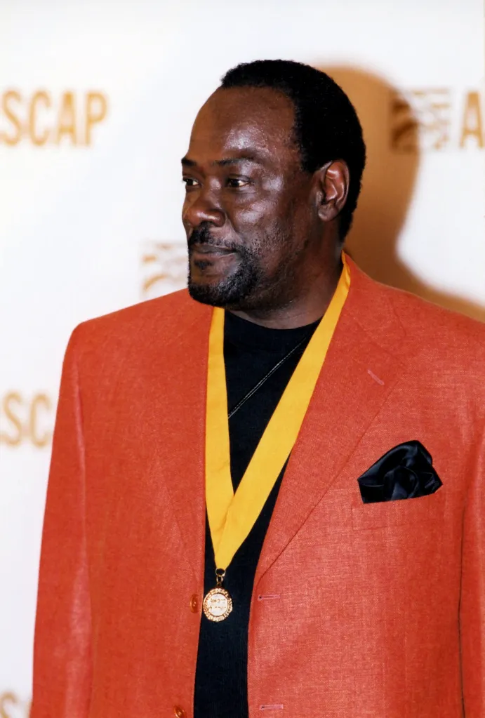 Ronald LaPread posing for photos on the red carpet.