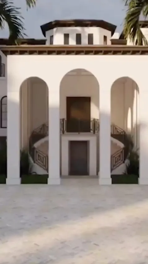 Illustration of the front exterior of a luxurious white mansion with arches and a driveway.