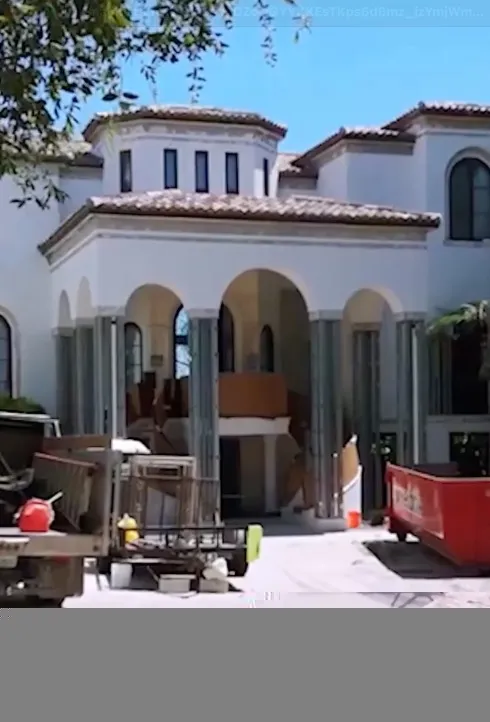Large white building under construction.
