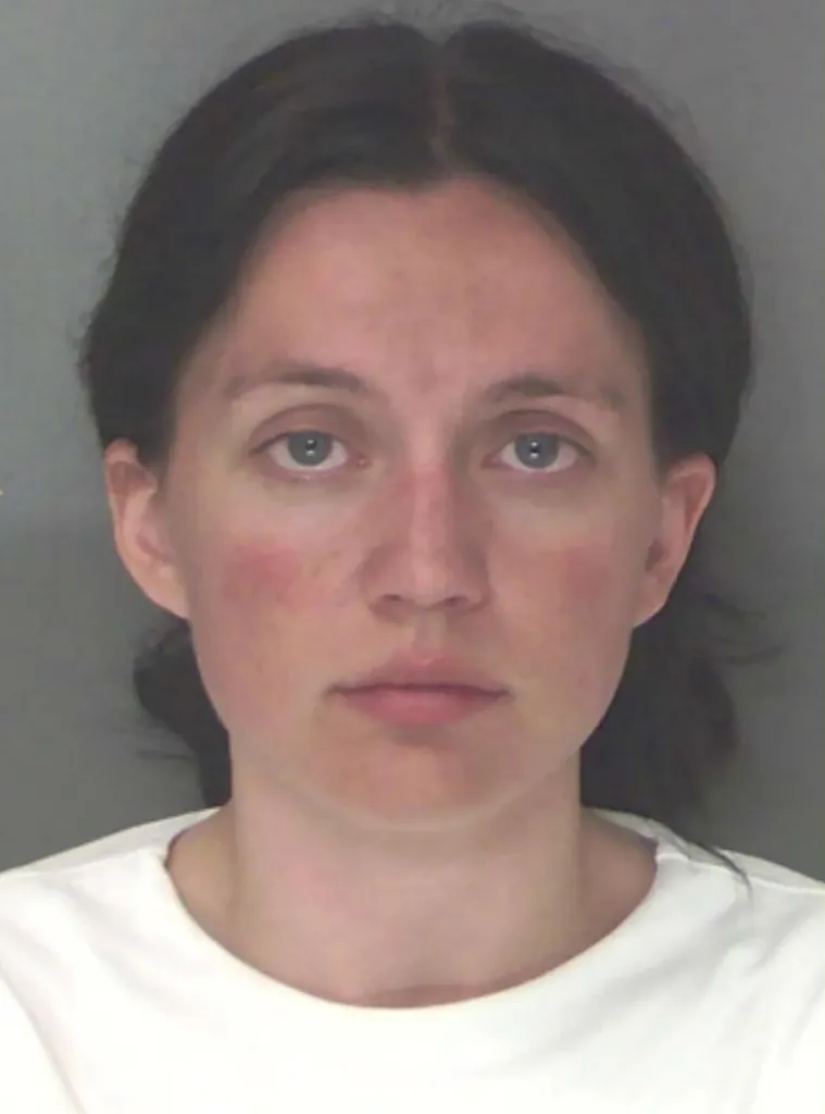 Mugshot of Maris Nichols, a former teacher and football staff member, facing charges of child molestation.