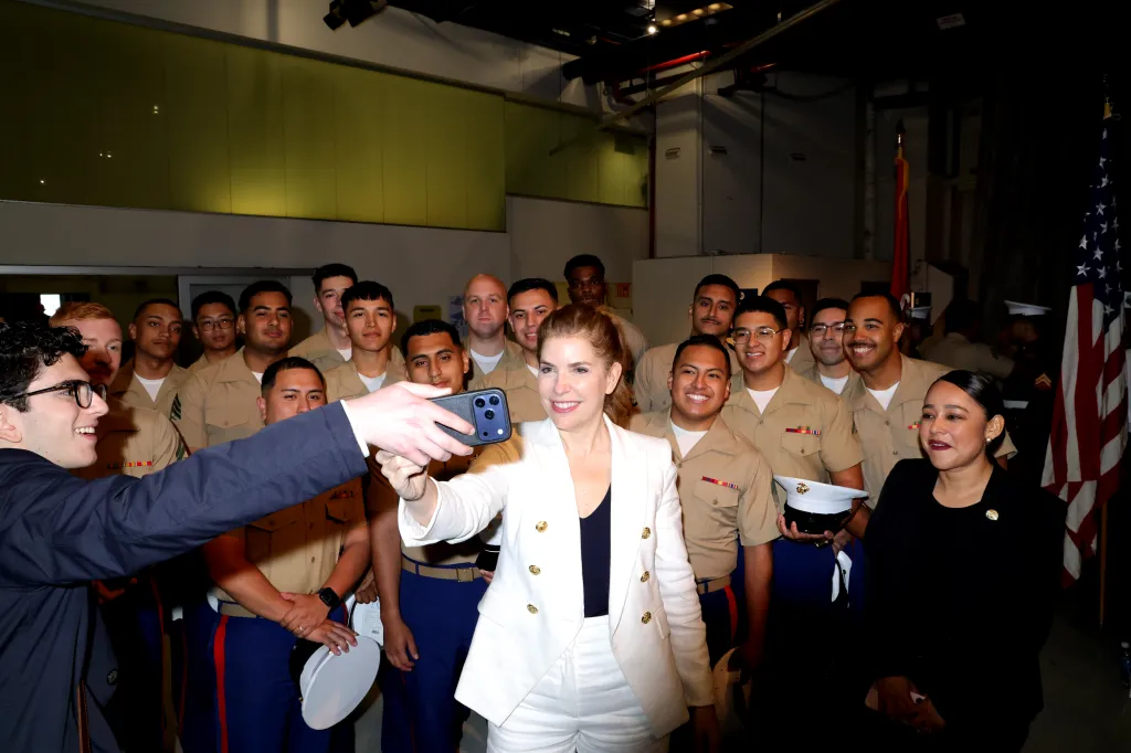 New York City Council Speaker Julie Menin taking a selfie with Marines and an aide at the Intrepid Museum's Memorial Day ceremony.