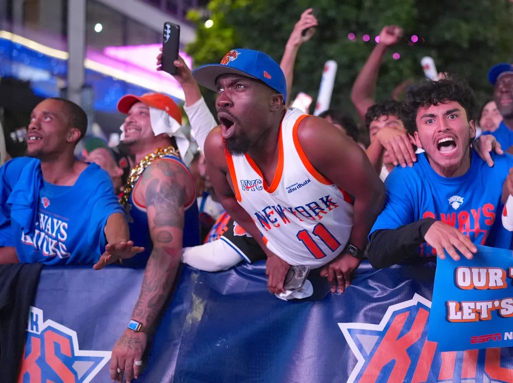 New York Knicks fans reacting with excitement at a watch party for Game 1 of the Eastern Conference Finals.