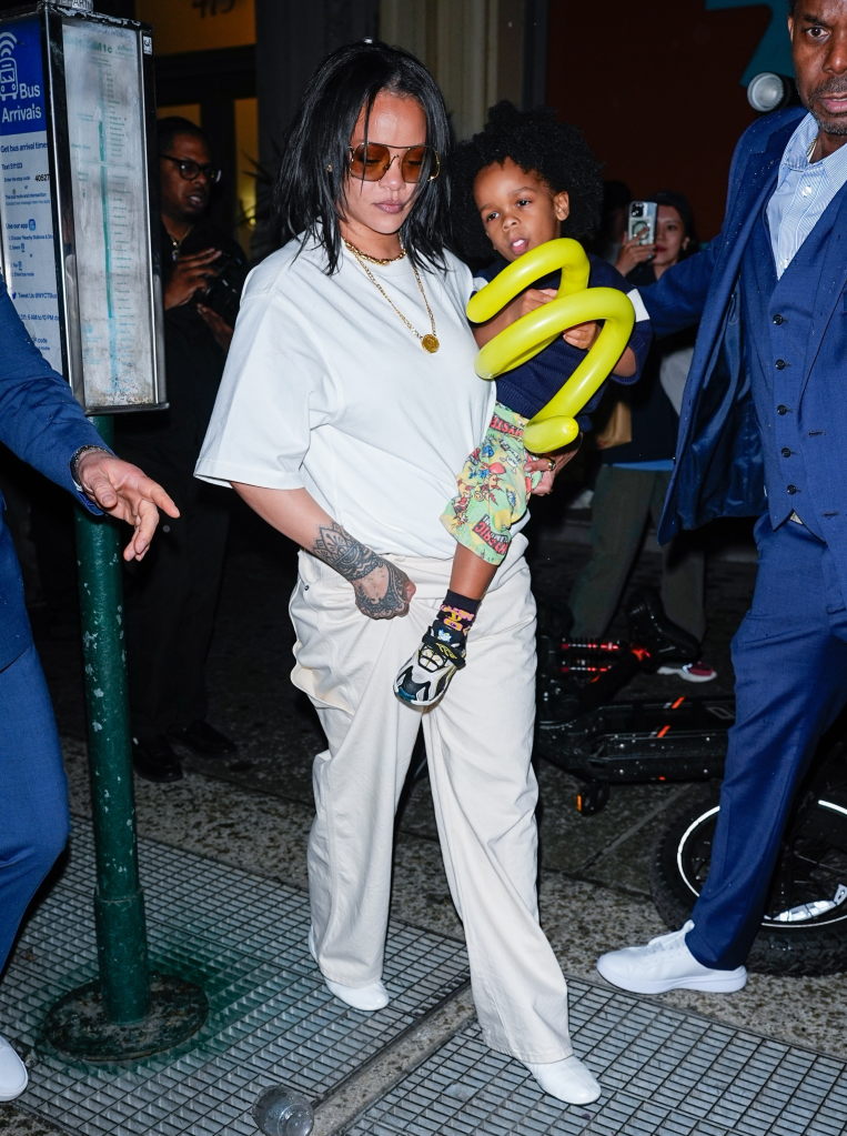 Rihanna holding her son RZA and a yellow balloon.