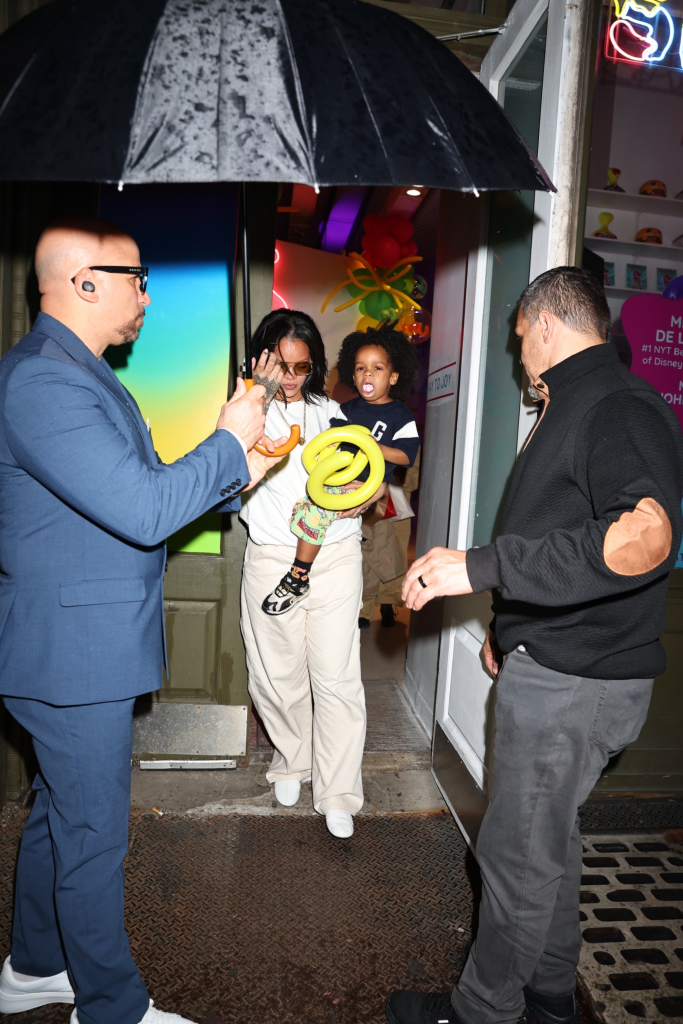 Rihanna carries her son RZA while leaving his birthday party in NYC.