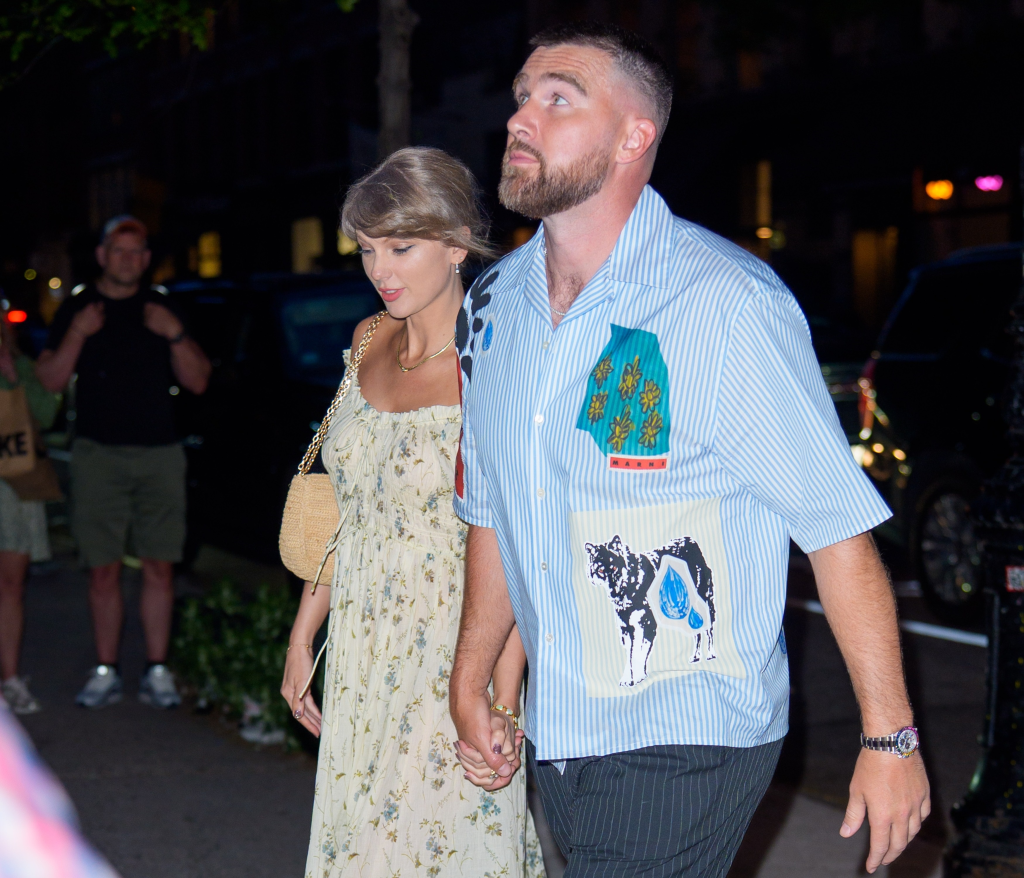 Taylor Swift and Travis Kelce walking hand-in-hand in New York City.