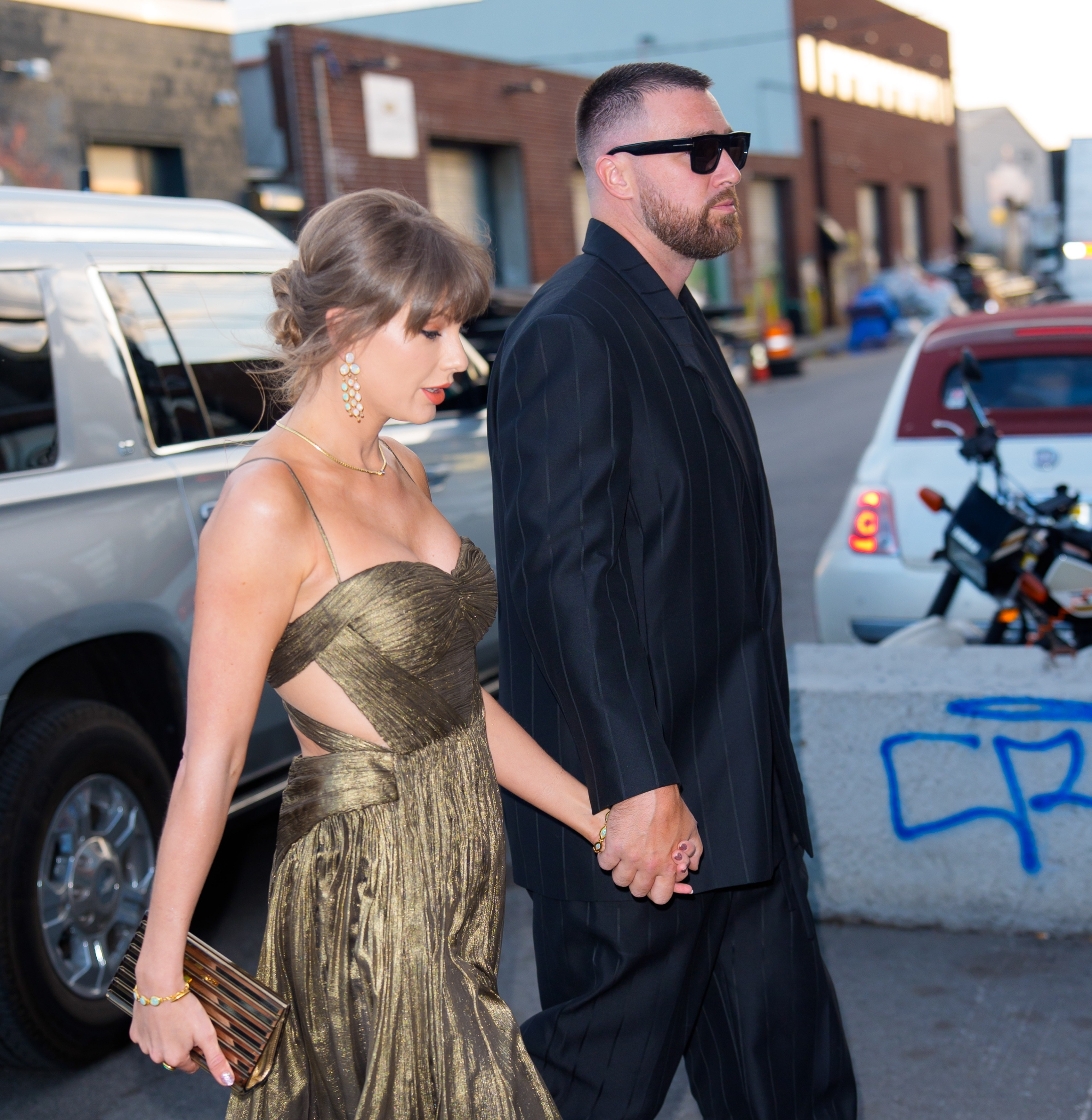 Taylor Swift and Travis Kelce walking hand-in-hand to a private event in Brooklyn.