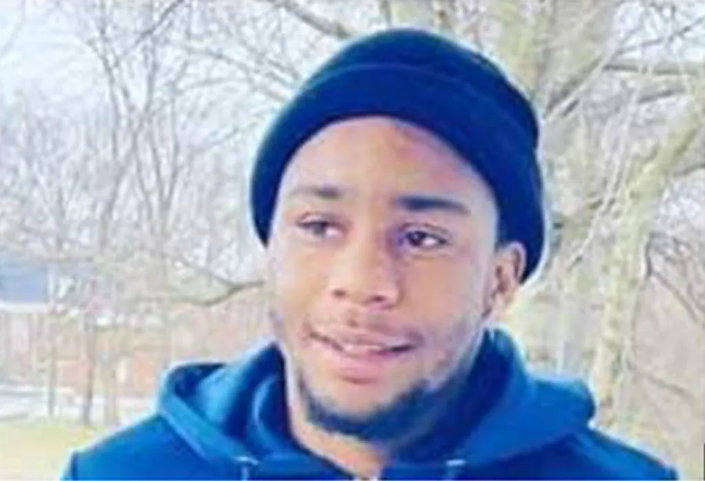 Terry Moses, a Black man with a beard and wearing a blue beanie and blue hoodie, looks slightly to his right.