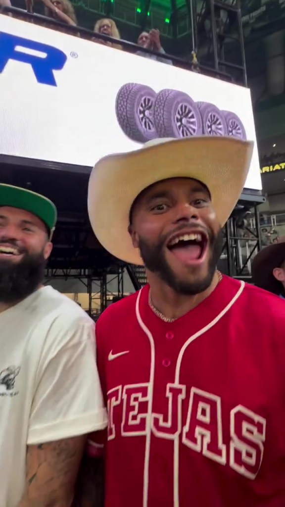 NFL star Dak Prescott wearing a cowboy hat and a red baseball jersey with 
