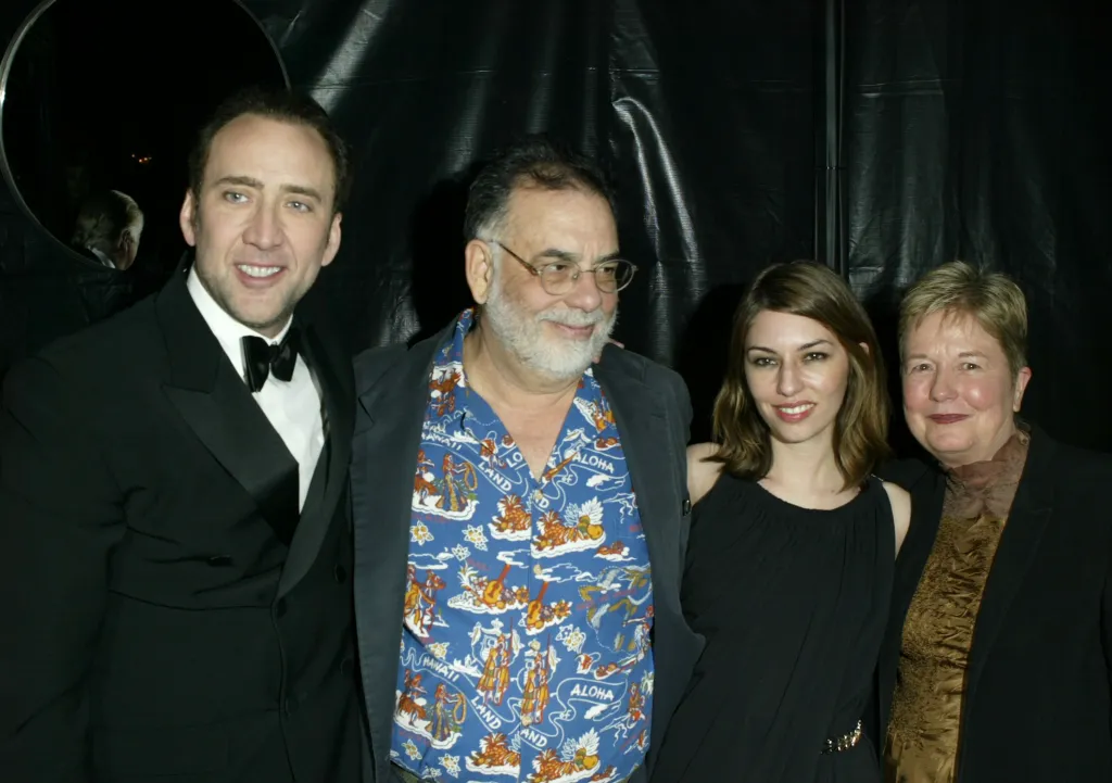Nicolas Cage, Francis Ford Coppola, Sofia Coppola, and Eleanor Coppola posing together.