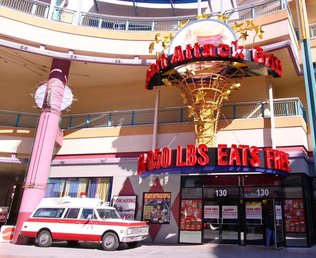 The Heart Attack Grill restaurant with an ambulance parked outside and a sign that reads 