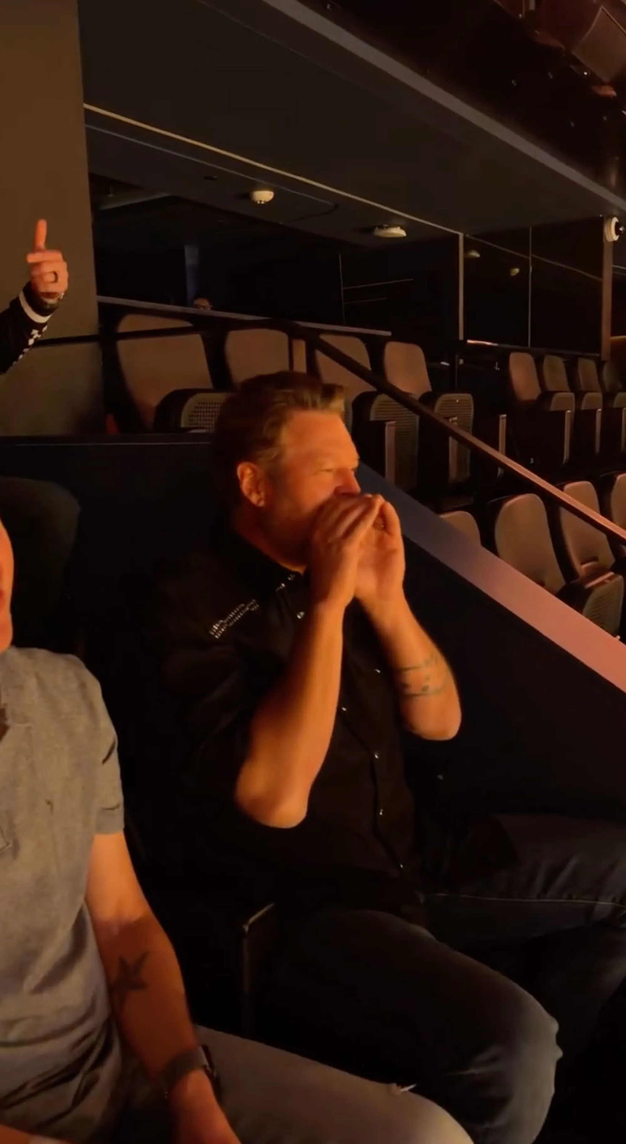 Blake Shelton watching a show.