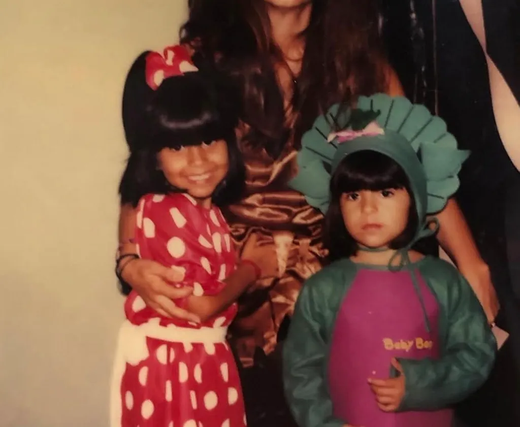 Shaina Montiel (L) and a younger girl posing while in costumes.