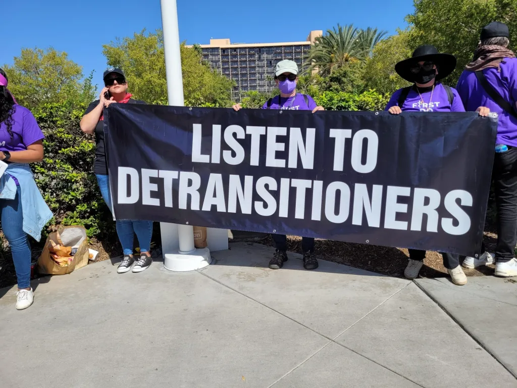 Protesters holding a banner that reads 