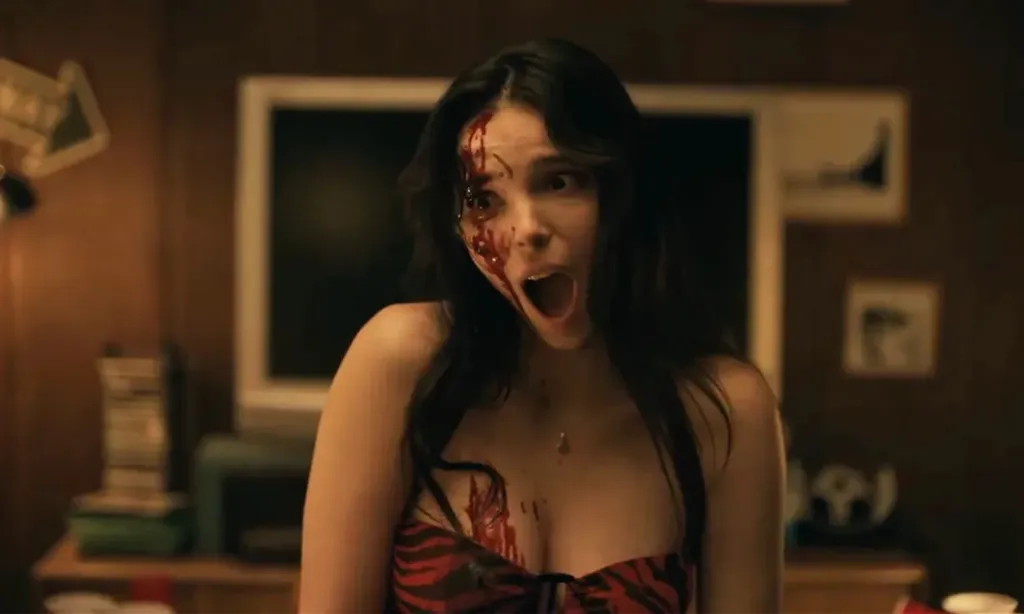 Inde Navarrette in still from the movie Obsession, with blood on her face and chest.