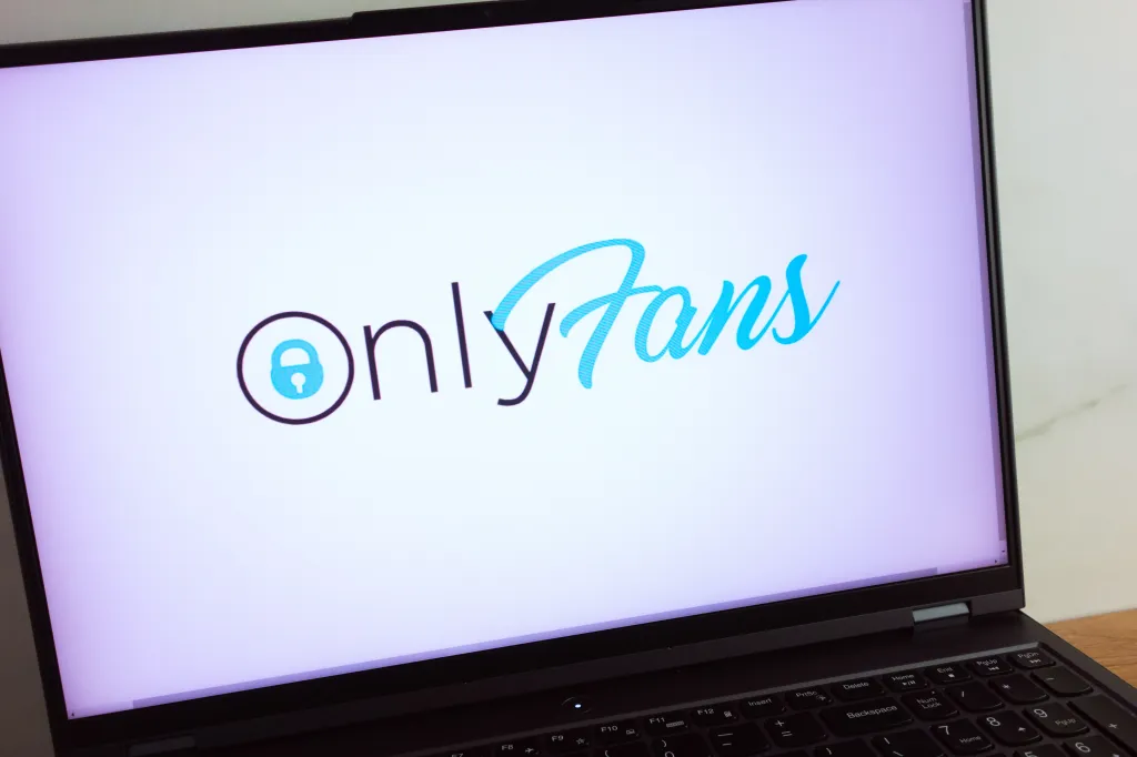 OnlyFans content subscription service logo displayed on a laptop computer screen.